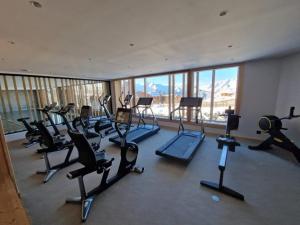 a gym with a bunch of exercise equipment in a building at Alpe d'Huez Houses - Chez Marlène - PHOENIX3 - Coup de coeur ski aux pieds avec piscine, spa, et fitness in L'Alpe-d'Huez