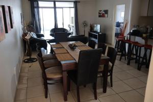 a dining table and chairs in a living room at Margate 3 Bed with Sea Views in Margate