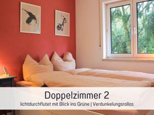 a bedroom with two beds and a window at Möbliert Wohnen Munich Airport Business Park in Hallbergmoos