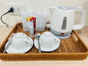 a basket with two tea cups and a blender at PMS Boutique Patong in Patong Beach