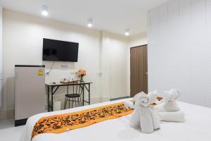 a hotel room with two towels on a bed at PMS Boutique Patong in Patong Beach