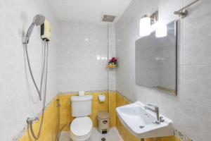 a bathroom with a toilet and a sink at PMS Boutique Patong in Patong Beach