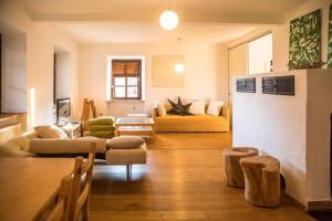 a living room with a couch and a table at Ferienwohnung Altes Schulhaus Greising in Deggendorf