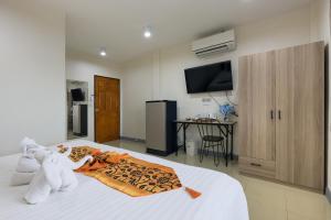 a bedroom with two stuffed animals laying on a bed at PMS Boutique Patong in Patong Beach