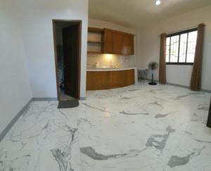 a kitchen with a marble floor in a room at JG Privspace in San Juan