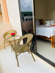 a room with a table and a chair and a bed at PMS Boutique Patong in Patong Beach