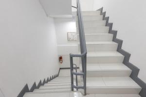 a staircase in a building with a metal handrail at PMS Boutique Patong in Patong Beach