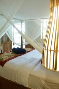 Giường trong phòng chung tại Melati bali villa