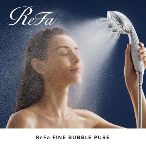 a woman spraying herself with a shower at Richmond Hotel Yokohama-Bashamichi in Yokohama