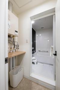 a bathroom with a tub and a toilet and a sink at FC Farnest Niseko in Kutchan +104 photos