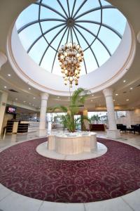 a large lobby with a large chandelier in the ceiling at פנטהאוז מול הים in Eilat +15 photos