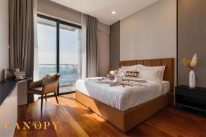 a bedroom with a bed and a chair and a window at The Manor Signature Residence, Kuala Lumpur in Kuala Lumpur +37 photos