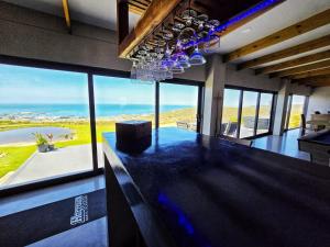 a kitchen with a bar with a view of the ocean at Sapphire St Helena bay in St. Helena Bay