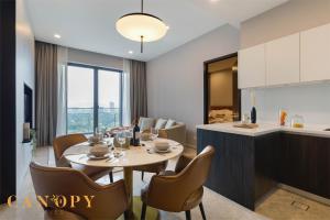 a dining room and kitchen with a table and chairs at The Manor Signature Residence, Kuala Lumpur in Kuala Lumpur