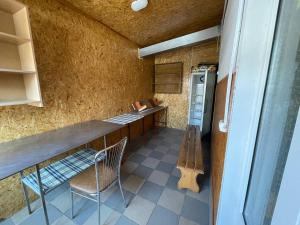 a kitchen with a counter and a chair and a refrigerator at Готель BonRe in Romny