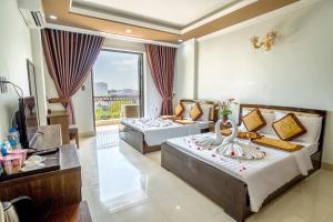 a hotel room with two beds and a balcony at Dat Anh Hotel in Hue +56 photos