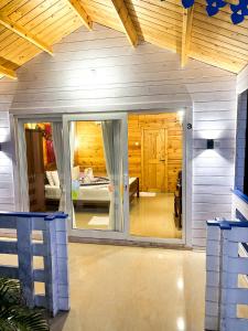 a room with a large glass window in a house at Red Crab Eco Resorts in Cabo de Rama +21 photos