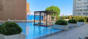 a swimming pool with a cage on the side of a building at Executive Suite Condo 1 in Dumaguete