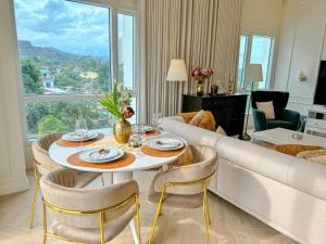 a living room with a table and a couch at The Suite- Luxurious City Skyline in Cebu City