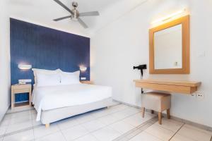 Een bed of bedden in een kamer bij Pal Beach