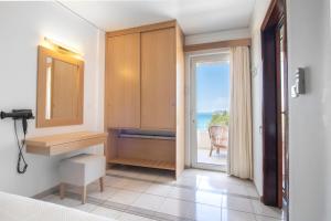 a bedroom with a door leading to the ocean at Pal Beach in Palaiochora +37 photos