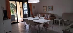 a living room with a table and a couch at Villa Kalos in Marinagri Resort in Policoro