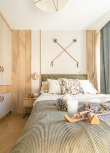 a bedroom with a bed with shoes on it at Cyrhla Apartamenty - sauna, playroom, free parking & wifi in Zakopane
