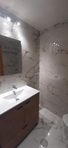 a bathroom with a sink and a mirror at Ribera Beach 1 Apartment Elisa in Mar de Cristal +15 photos