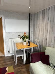 a dining room with a table and a couch at New Hill Farm Shawforth in Rochdale