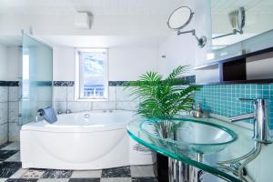 a bathroom with a tub and a glass sink at Meteor Shower in Sapporo