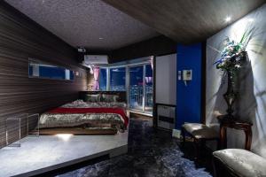 a bedroom with a bed and a blue wall at Meteor Shower in Sapporo