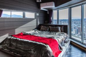 a bedroom with a large bed in a room with windows at Meteor Shower in Sapporo +37 photos