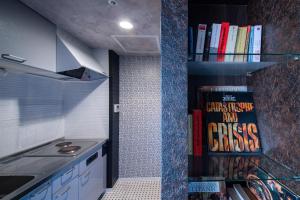 a kitchen with a book shelf filled with books at Meteor Shower in Sapporo
