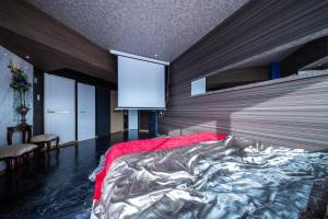a bedroom with a large bed with a red blanket at Meteor Shower in Sapporo