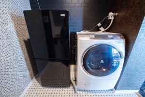 a washer and dryer in a bathroom at Meteor Shower in Sapporo