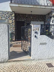 an entrance to a stone building with a gate at House Prosperity in Amora