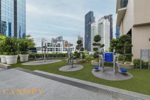 a park with a statue in the middle of a city at The Manor Signature Residence, Kuala Lumpur in Kuala Lumpur