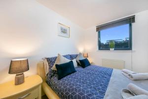 a bedroom with a bed and a desk and a window at Riverside Lodge in Aberdeen