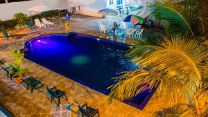 an overhead view of a swimming pool with chairs and a palm tree at El Paraiso in Montañita