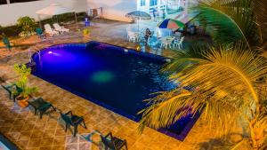 een uitzicht over een zwembad met stoelen en een palmboom bij El Paraiso in Montañita