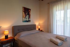 a bedroom with a bed with two towels on it at Villa View in Porto Heli +23 photos