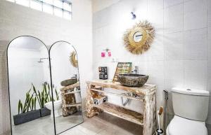 a bathroom with a sink and a toilet and a mirror at Villa casa in Seminyak