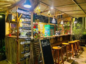 a restaurant with a bar with stools in front of it at Angels Homestay & Coffee - Măng Đen in Kon Von Kla