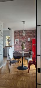 a dining room with a table and chairs and a brick wall at Apartment Stella Danica in Čatež ob Savi