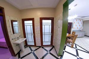 a bathroom with a sink and four windows at Mera Homes in Kampala +1 photo