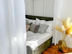 a bed with white sheets and pillows in a room at Ro42om Schönewerd in Schönenwerd