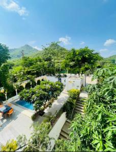 a view of a resort with a pool and trees at Royal Heritage Haveli Udaipur in Udaipur +65 photos