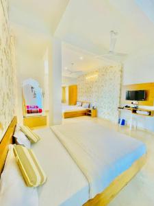 a large white room with a large bed in it at Royal Heritage Haveli Udaipur in Udaipur