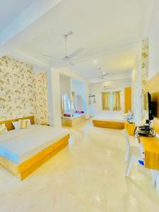 a large bedroom with two beds and a desk at Royal Heritage Haveli Udaipur in Udaipur