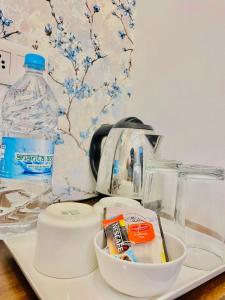 a counter with a sink with a bowl of food and a bottle of water at Royal Heritage Haveli Udaipur in Udaipur